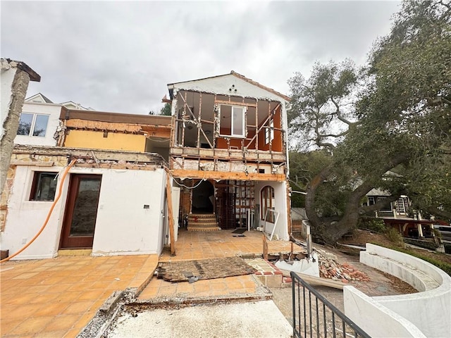 back of property with a patio area and stucco siding