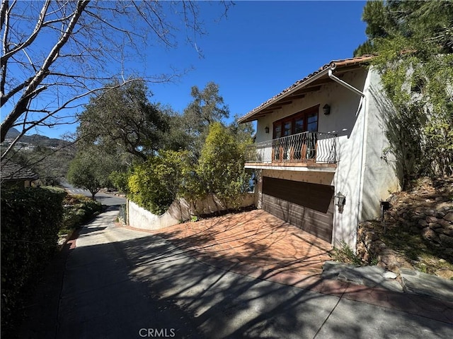 view of home's exterior with a balcony and stucco siding