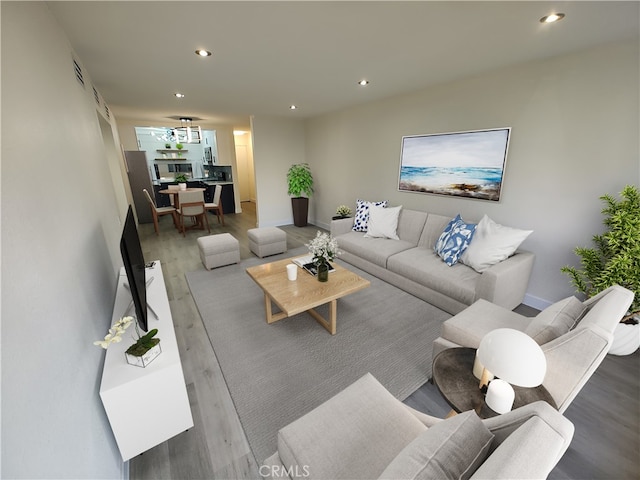 living area featuring visible vents, wood finished floors, and recessed lighting