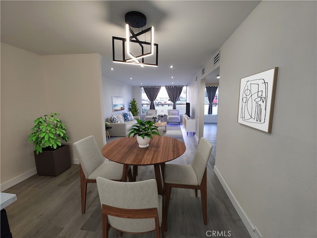 dining space with recessed lighting, visible vents, baseboards, and wood finished floors