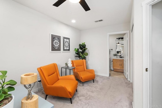 sitting room featuring ceiling fan, recessed lighting, light carpet, visible vents, and baseboards