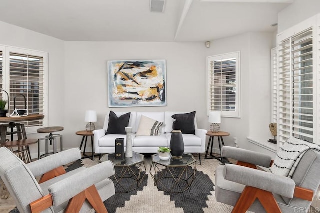 living area with visible vents and baseboards