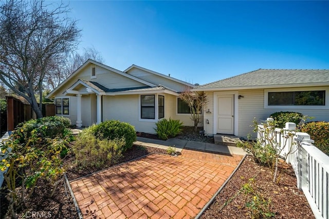 ranch-style home with fence and a patio