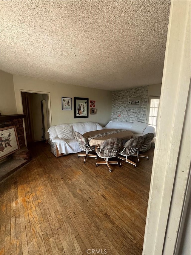 living room featuring a textured ceiling and wood finished floors