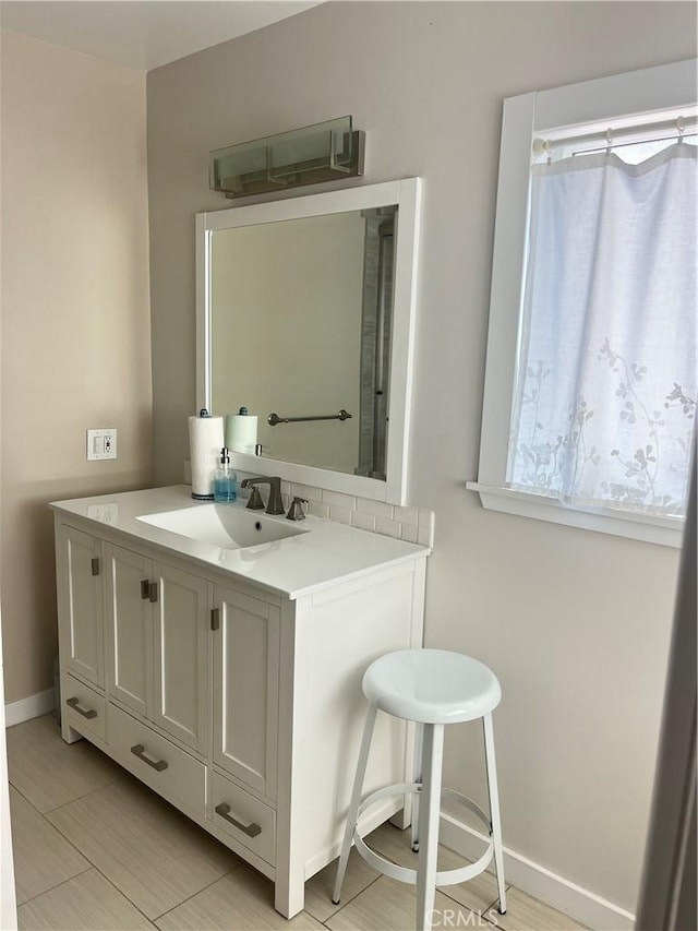 bathroom with vanity and baseboards