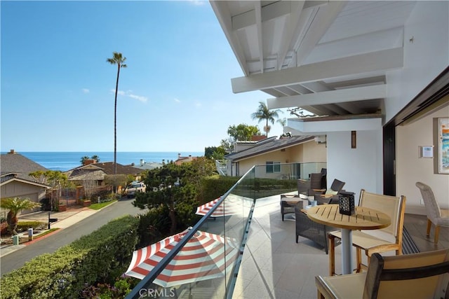 view of patio with a water view and a balcony