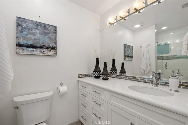 bathroom featuring visible vents, backsplash, toilet, a stall shower, and vanity