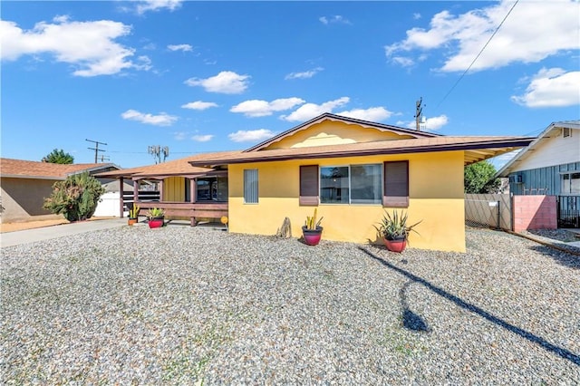 view of front of property featuring fence and stucco siding