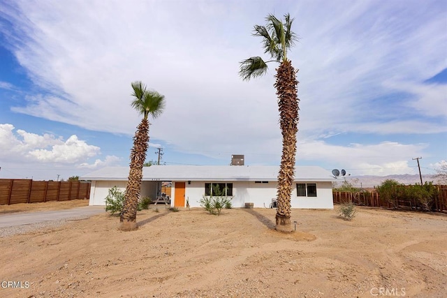 ranch-style house with driveway, an attached garage, and fence