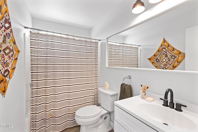 bathroom featuring toilet and vanity