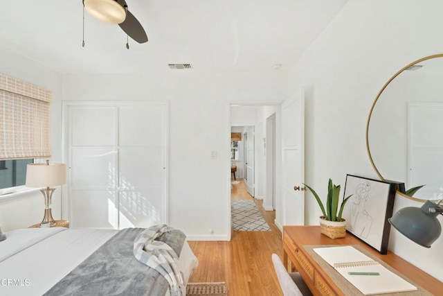 bedroom with ceiling fan, a closet, light wood-type flooring, and visible vents