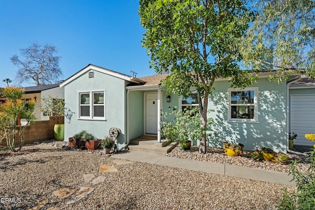 view of front of property featuring fence and stucco siding