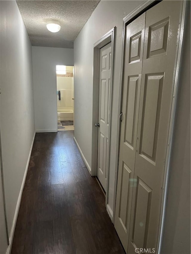201 W Raymond St, Compton, CA 90220 - hallway with a textured ceiling and dark wood-type flooring