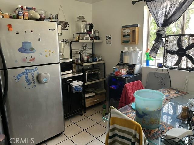 201 W Raymond St, Compton, CA 90220 - kitchen featuring freestanding refrigerator and light tile patterned flooring