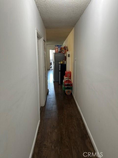 201 W Raymond St, Compton, CA 90220 - hallway with wood finished floors and a textured ceiling