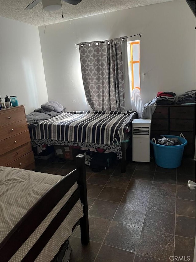 201 W Raymond St, Compton, CA 90220 - bedroom featuring stone tile floors, a textured ceiling, and ceiling fan