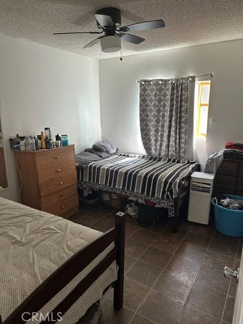 201 W Raymond St, Compton, CA 90220 - bedroom with a textured ceiling and a ceiling fan