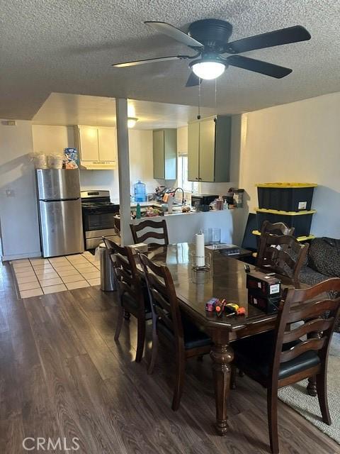 201 W Raymond St, Compton, CA 90220 - dining space featuring a textured ceiling, ceiling fan, and light wood finished floors