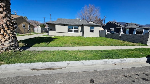 view of front facade featuring fence, crawl space, a residential view, stucco siding, and a front lawn