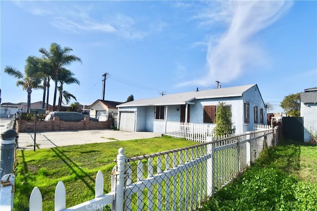 ranch-style house featuring a fenced front yard, a front yard, concrete driveway, and stucco siding