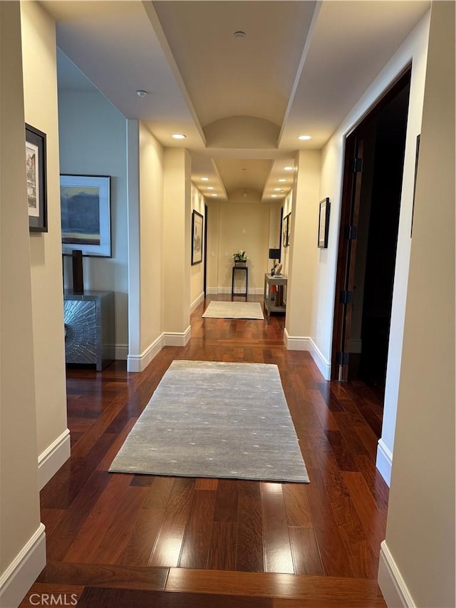 hallway featuring dark wood-style floors, recessed lighting, and baseboards