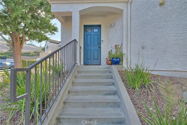 view of exterior entry featuring stucco siding