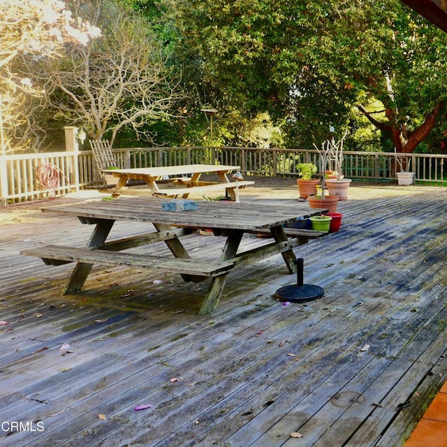 wooden terrace featuring outdoor dining area