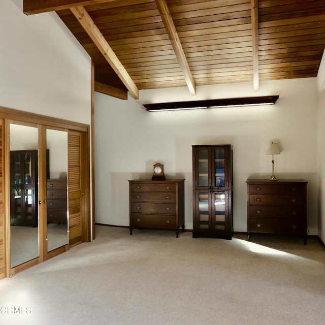 unfurnished bedroom with light carpet, wood ceiling, beamed ceiling, and french doors