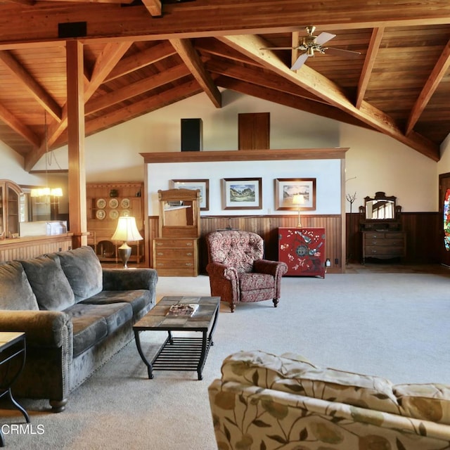 living area with lofted ceiling with beams, a wainscoted wall, wood ceiling, and carpet flooring