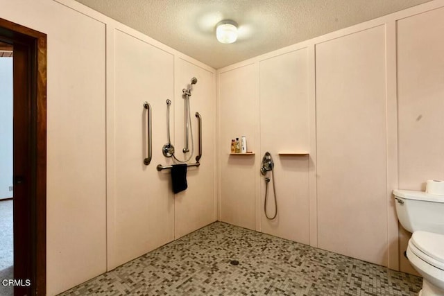 full bathroom featuring toilet, a textured ceiling, tile patterned floors, and walk in shower