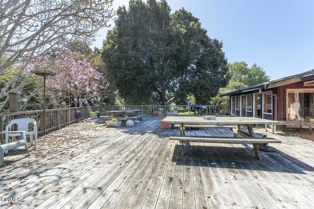 wooden terrace featuring outdoor dining space