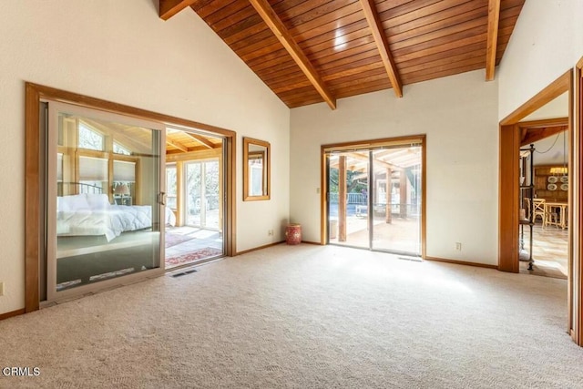 spare room with visible vents, carpet flooring, baseboards, and beam ceiling