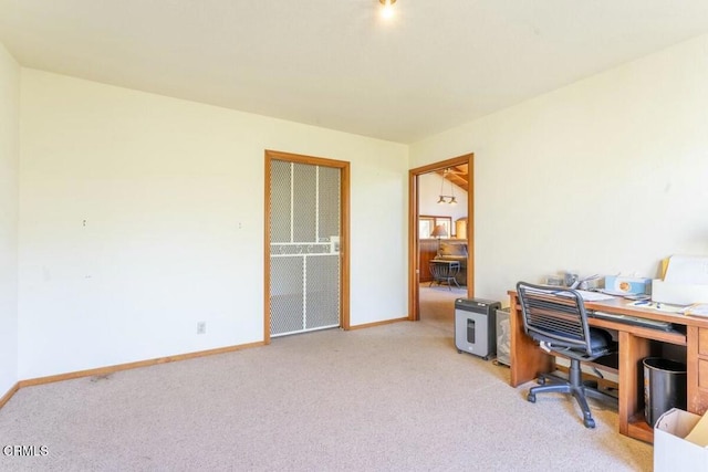 office area featuring baseboards and light colored carpet