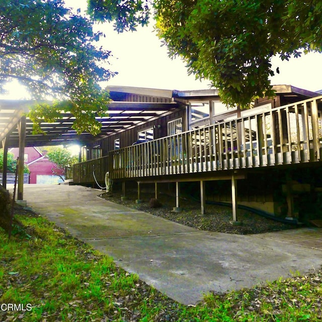 rear view of property featuring a wooden deck