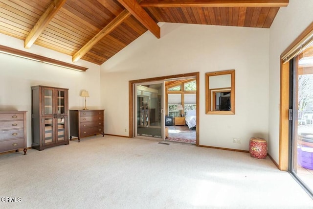 interior space featuring a wealth of natural light, wooden ceiling, beam ceiling, and carpet floors