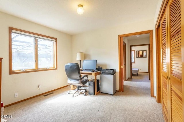 carpeted home office with visible vents and baseboards