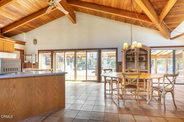 dining room with beamed ceiling, high vaulted ceiling, tile patterned flooring, wooden ceiling, and a notable chandelier