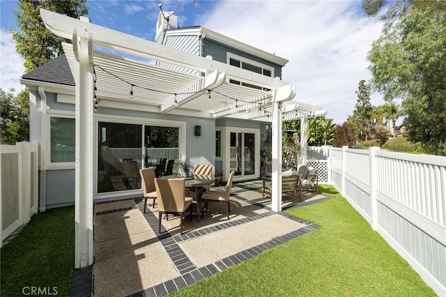 rear view of property featuring roof with shingles, a yard, a patio area, a pergola, and a fenced backyard