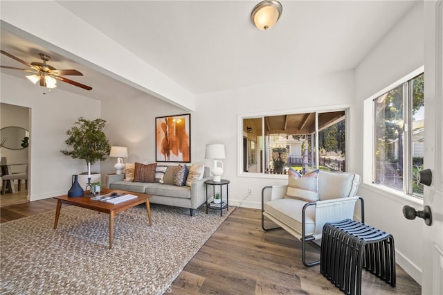 living room with a ceiling fan, baseboards, and wood finished floors