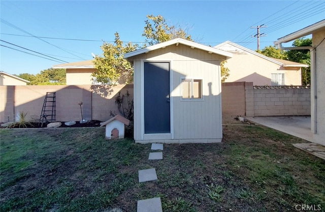 view of shed with a fenced backyard