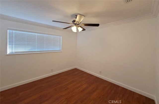unfurnished room featuring baseboards, ornamental molding, and wood finished floors