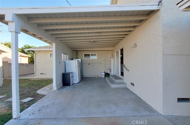 view of patio featuring fence, a carport, and entry steps
