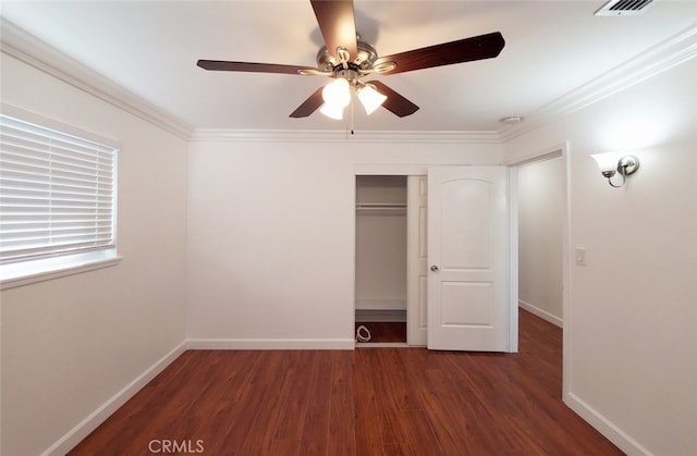 unfurnished bedroom featuring baseboards, ornamental molding, and wood finished floors