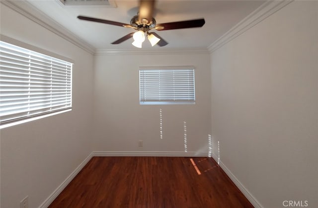 spare room featuring baseboards, a ceiling fan, wood finished floors, and crown molding