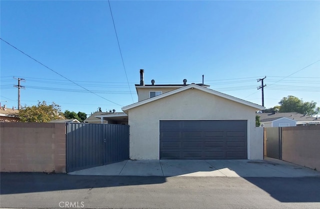 garage featuring a gate and fence