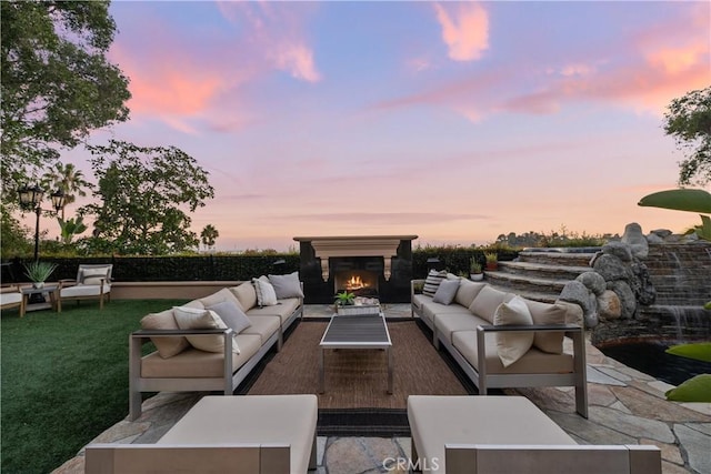 view of patio with an outdoor living space with a fireplace