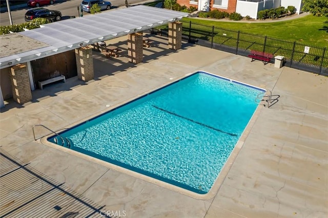 view of swimming pool featuring a fenced in pool, a patio area, and fence