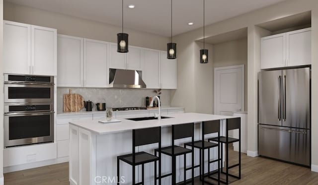 kitchen featuring a center island with sink, stainless steel appliances, light countertops, white cabinets, and under cabinet range hood