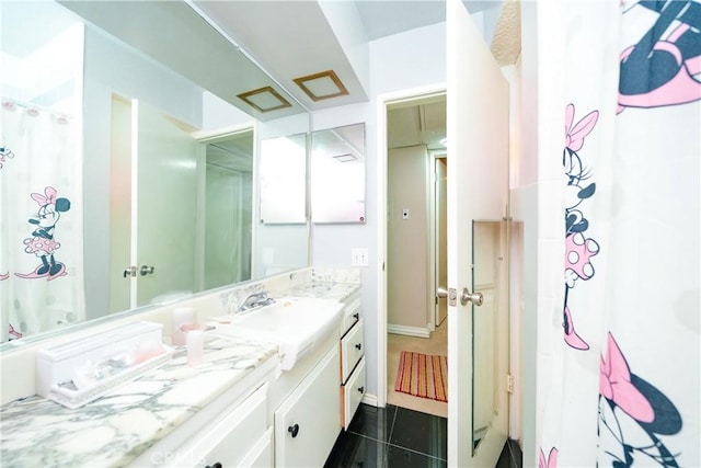 bathroom with tile patterned flooring and vanity