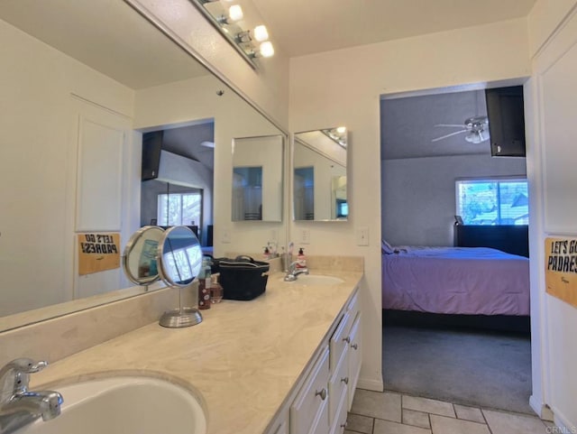 full bathroom featuring a sink, double vanity, connected bathroom, and a ceiling fan